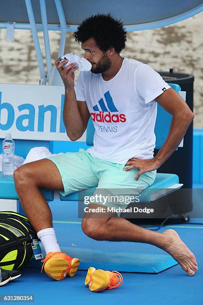 Jo-Wilfried Tsonga of France smells his sock while waiting for his foot to be treated during a practice session ahead of the 2017 Australian Open at...