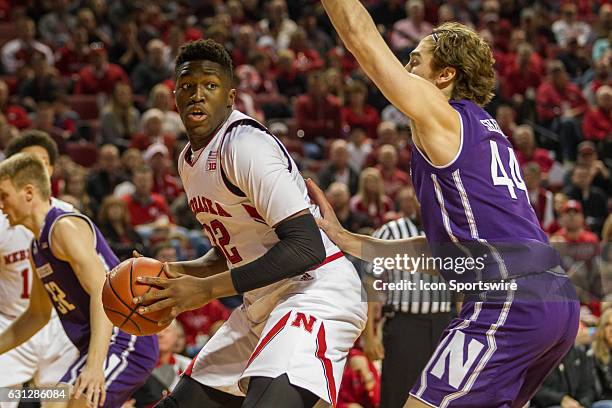 Nebraska Cornhuskers center Jordy Tshimanga works his way to the basket against Northwestern Wildcats forward Gavin Skelly during the first half of a...