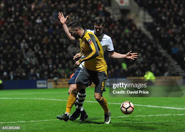 Lucas Peres of Arsenal backheels the ball under pressure by Paul Huntington of Preston during the match between Preston North End and Arsenal at...