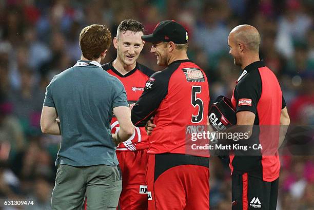 Renegades wicketkeeper Peter Nevill is assessed by medical staff after being hit in the head by the ball during the Big Bash League match between the...