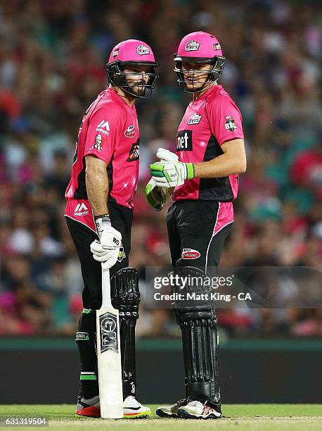 Michael Lumb and Daniel Hughes of the Sixers talk between overs during the Big Bash League match between the Sydney Sixers and the Melbourne...