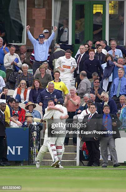 Warwickshire's Dougie Brown hugs teammate Neil Carter after he hit a boundary off the last ball of the match to win the Benson and Hedges Cup Semi...