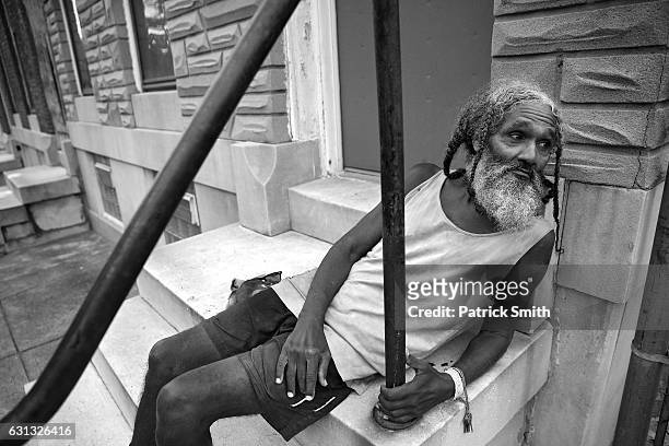 Keith Boissiere looks up the street from his front steps on September 15, 2016 in Baltimore, Maryland. Acts of violence are unfortunately what...
