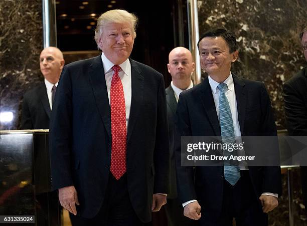 President-elect Donald Trump and Jack Ma, Chairman of Alibaba Group, emerge from the elevators to speak to reporters following their meeting at Trump...