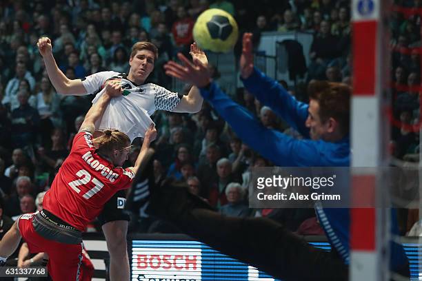 Finn Lemke of Germany tries to score against Marian Klopcic and goalkeeper Thomas Bauer of Austria during the international handball friendly match...