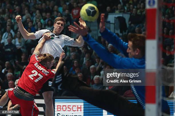 Finn Lemke of Germany tries to score against Marian Klopcic and goalkeeper Thomas Bauer of Austria during the international handball friendly match...