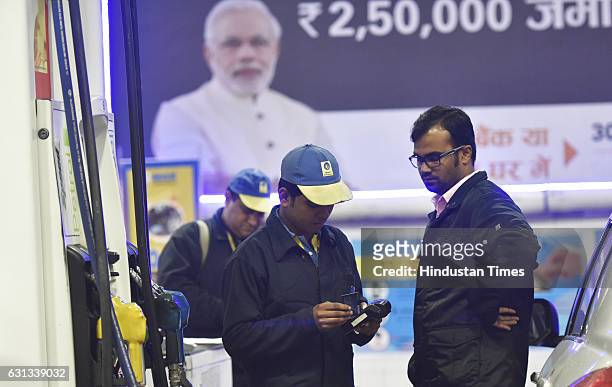 Petrol pump accepting payment through debit and credit cards on January 9, 2017 in New Delhi, India. Government cleared that credit and debit cards...