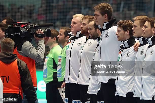 Camera man walks past the german team prior to the international handball friendly match between Germany and Austria at Rothenbach-Halle on January...