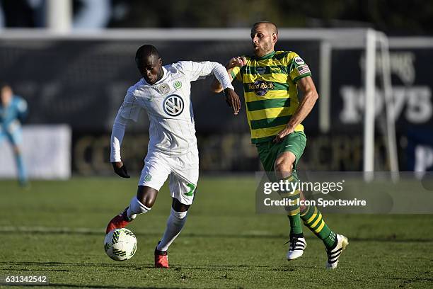 Wolfsburg midfielder Amara Conde protects the ball from Tampa Bay Rowdies midfielder Keith Savage during the first half of a Florida Cup soccer game...