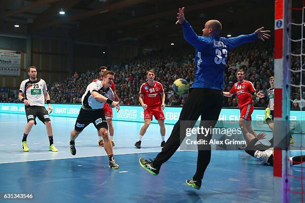 Niclas Pieczkowski of Germany scores against goalkeeper Goran Aleksic of Austria during the international handball friendly match between Germany and...