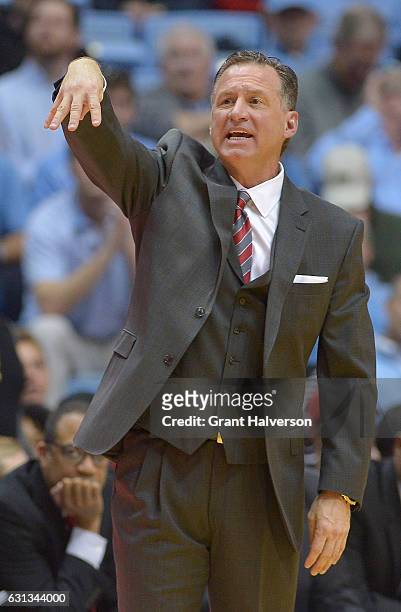 Head coach Mark Gottfried of the North Carolina State Wolfpack directs his team against the North Carolina Tar Heels during the game at the Dean...
