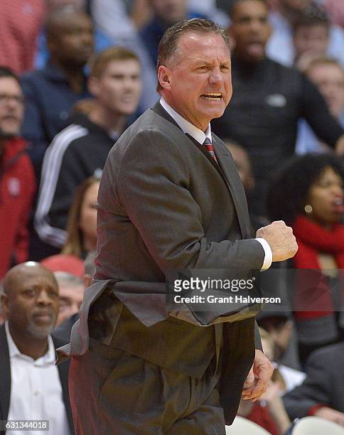 Head coach Mark Gottfried of the North Carolina State Wolfpack directs his team against the North Carolina Tar Heels during the game at the Dean...