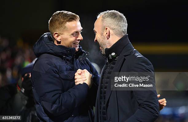Garry Monk manager of Leeds United and Shaun Derry manager of Cambridge Unitedshake hands prior to the Emirates FA Cup Third Round match between...