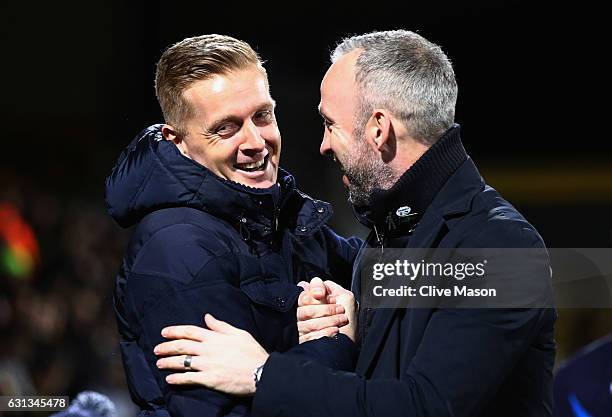 Garry Monk manager of Leeds United and Shaun Derry manager of Cambridge Unitedshake hands prior to the Emirates FA Cup Third Round match between...