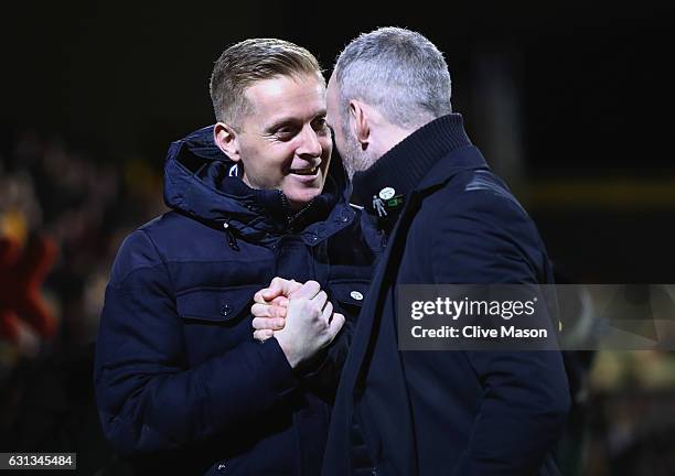 Garry Monk manager of Leeds United and Shaun Derry manager of Cambridge Unitedshake hands prior to the Emirates FA Cup Third Round match between...