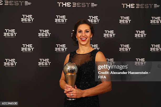 Carli Lloyd of the United States and Houston Dash poses with The Best FIFA Women's Player Award during The Best FIFA Football Awards at TPC Studio on...