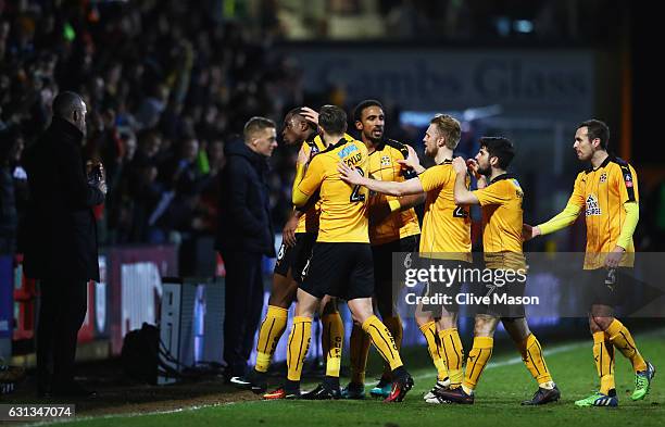 Uche Ikpeazu of Cambridge United celebrates with team mates as he scores their first goal during the Emirates FA Cup Third Round match between...