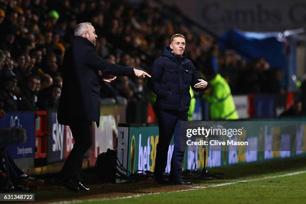 Shaun Derry manager of Cambridge United and Garry Monk manager of Leeds United gives instructions during the Emirates FA Cup Third Round match...