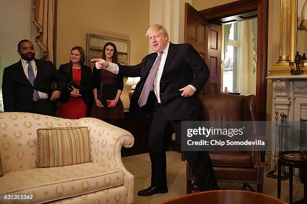 British Foreign Minister Boris Johnson rises to see a statue bust of former UK Prime Minister Winston Churchill in the office of Speaker of the House...