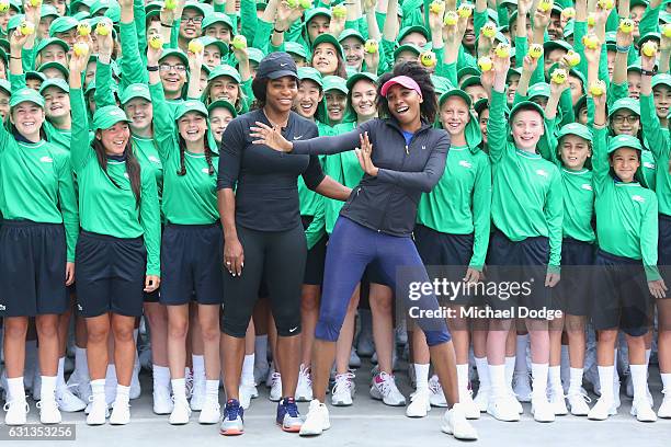 Serena Williams and sister Venus Williams of the USA pose with over 380 Australian Open ballkids for the annual welcome ceremony during a practice...