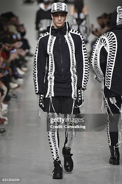 Model walks the runway at the KTZ Autumn Winter 2017 fashion show during London Menswear Fashion Week on January 8, 2017 in London, United Kingdom.