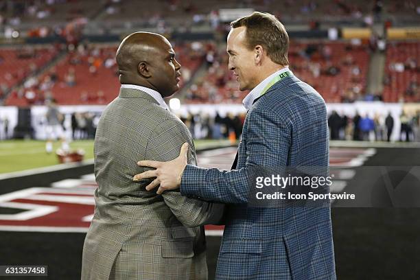 Former NFL players Anthony "Booger" McFarland and Peyton Manning talk on before the 2017 College Football National Championship Game between the...
