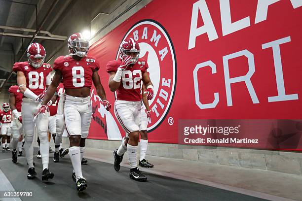 Wide receiver Derek Kief, defensive back Jared Mayden and tight end Irv Smith Jr. #82 of the Alabama Crimson Tide walk to the field prior to the 2017...