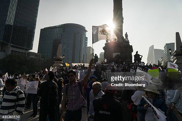 Demonstrators gather and hold signs during a protest against the gasoline price hike in Mexico City, Mexico, on Monday, Jan. 9, 2017. The government...