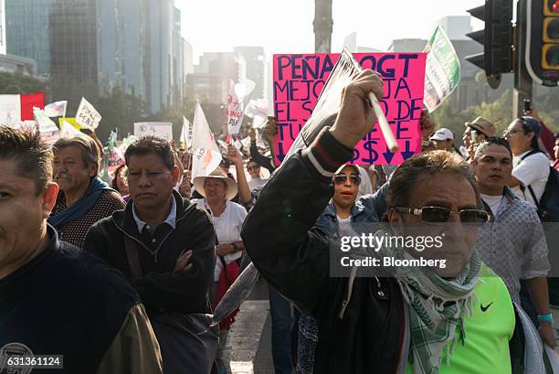 Demonstrators gather and hold signs during a protest against the gasoline price hike in Mexico City, Mexico, on Monday, Jan. 9, 2017. The government...