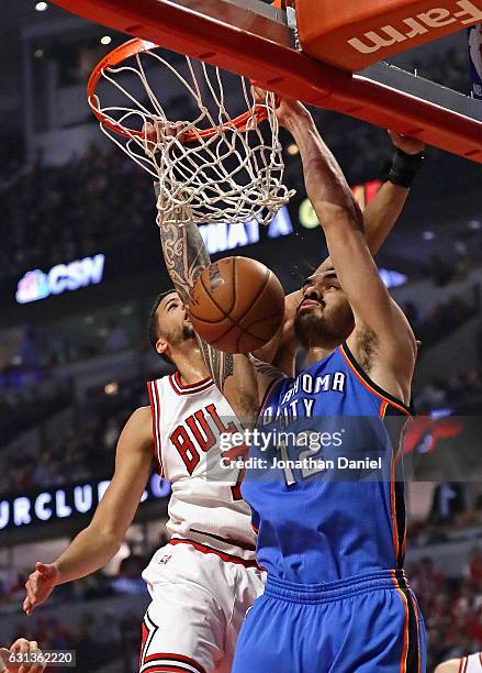 Steven Adams of the Oklahoma City Thunder dunks against Michael Carter-Williams of the Chicago Bulls at the United Center on January 9, 2017 in...