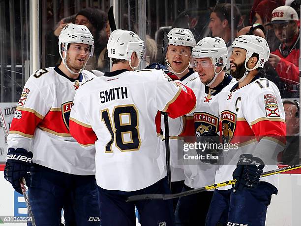 Jussi Jokinen of the Florida Panthers is congratulated by teammates Mark Pysyk,Reilly Smith and Derek MacKenzie after Jokinen scored an empty net...