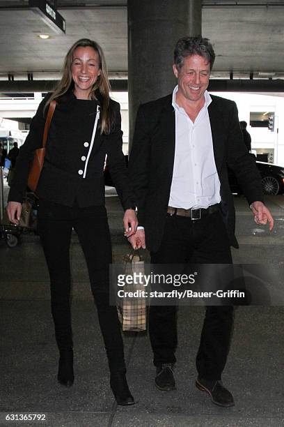 Hugh Grant and Anna Elisabet Eberstein are seen at LAX on January 09, 2017 in Los Angeles, California.