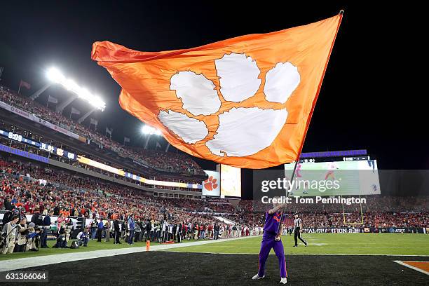 Clemson Tigers cheerleader waves a flag in the end zone during in the 2017 College Football Playoff National Championship Game between the Alabama...