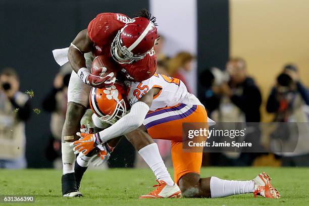 Cornerback Cordrea Tankersley of the Clemson Tigers tackles running back Bo Scarbrough of the Alabama Crimson Tide during the second half of the 2017...