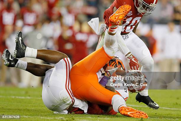 Linebacker Rashaan Evans of the Alabama Crimson Tide tackles tight end Jordan Leggett of the Clemson Tigers during the first half of the 2017 College...