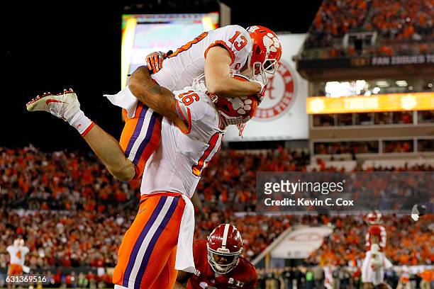 Wide receiver Hunter Renfrow of the Clemson Tigers celebrates with tight end Jordan Leggett after making a 2-yard game-winning touchdown reception...
