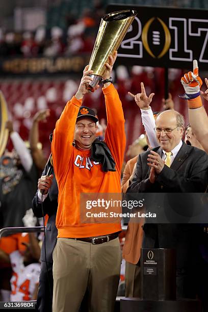 Head coach Dabo Swinney of the Clemson Tigers celebrates with the College Football Playoff National Championship Trophy after defeating the Alabama...