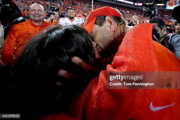 Head coach Dabo Swinney of the Clemson Tigers celebrates with his wife, Kathleen Swinney, after defeating the Alabama Crimson Tide 35-31 to win the...