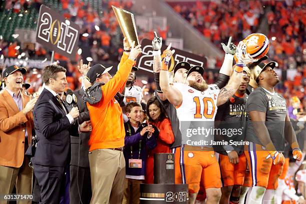 Head coach Dabo Swinney of the Clemson Tigers celebrates with the College Football Playoff National Championship Trophy after defeating the Alabama...