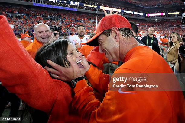 Head coach Dabo Swinney of the Clemson Tigers celebrates with his wife, Kathleen Swinney, after defeating the Alabama Crimson Tide 35-31 to win the...