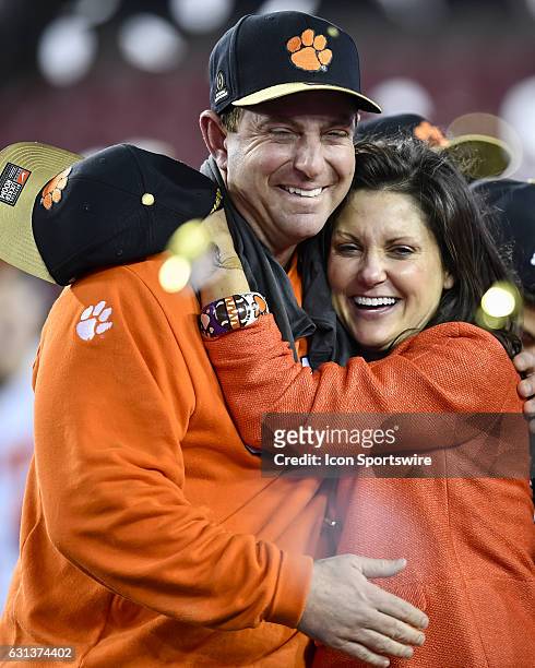 Clemson University head coach Dabo Swinney shares a special moment with his wife Kathleen during the award ceremony after the second half of the CFP...