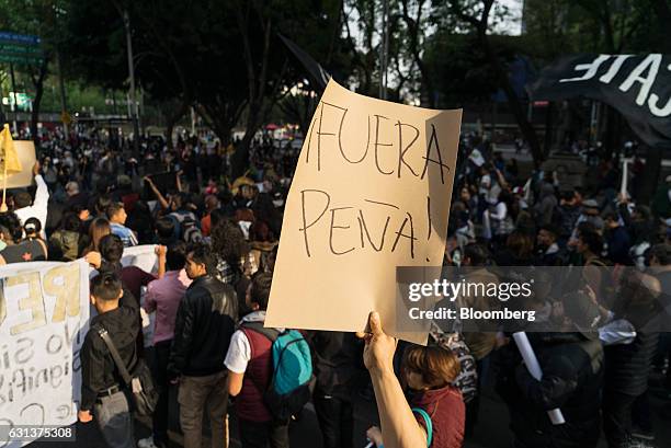 Demonstrators hold signs as they march during a protest against the gasoline price hike in Mexico City, Mexico, on Monday, Jan. 9, 2017. The...