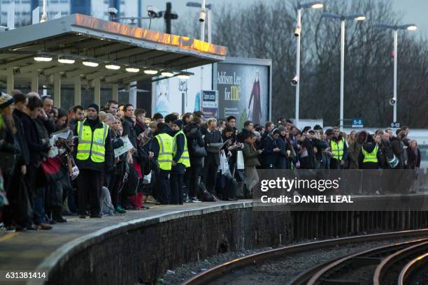 Commuters wait on a platform to catch a train toward central London at Clapham Junction station on January 10, 2017 after strike action by Southern...