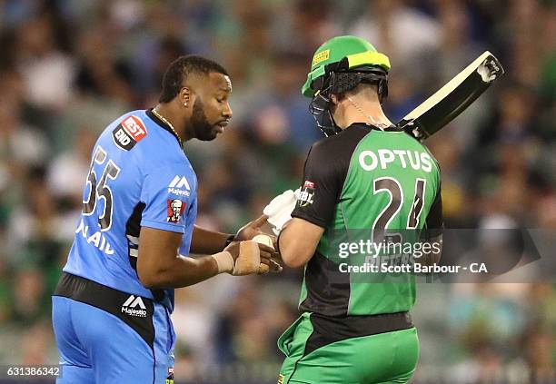 Kevin Pietersen of the Stars inspects the taping on the hand of bowler Kieron Pollard of the Strikers during the Big Bash League match between the...