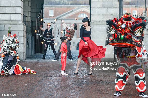 Model Yomiko Chen poses with a Chinese Lion and Unicorn, mesmerising fire breathers and talented children from the Chinese community, at the launch...