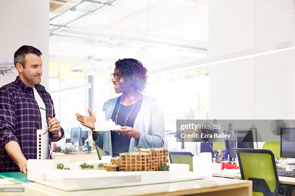 Creative coworkers discuss model ideas