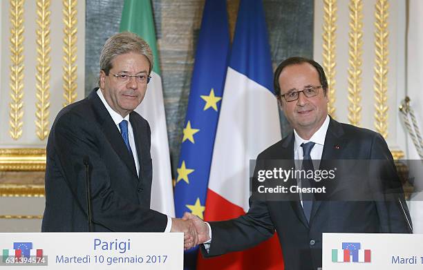 Italian Prime Minister Paolo Gentiloni shakes hand with French President Francois Hollande after their joint press conference at the Elysee...