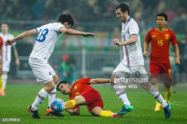 Deng Hanwen of China and Elmar Bjarnason of Iceland compete for the ball during the 2017 China Cup International Football Championship match between...
