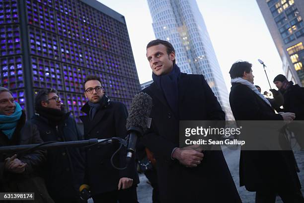 French independent presidential candidate Emmanuel Macron speaks to the media after he laid flowers at a memorial to the December 19 terror attack at...