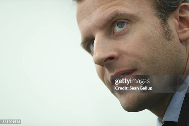 French independent presidential candidate Emmanuel Macron chats learns about a training program for refugees at a train repair facility of German...
